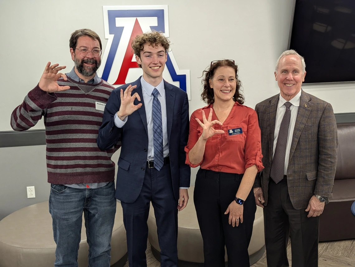 group of people standing in front of block 'A' showing bear down sign