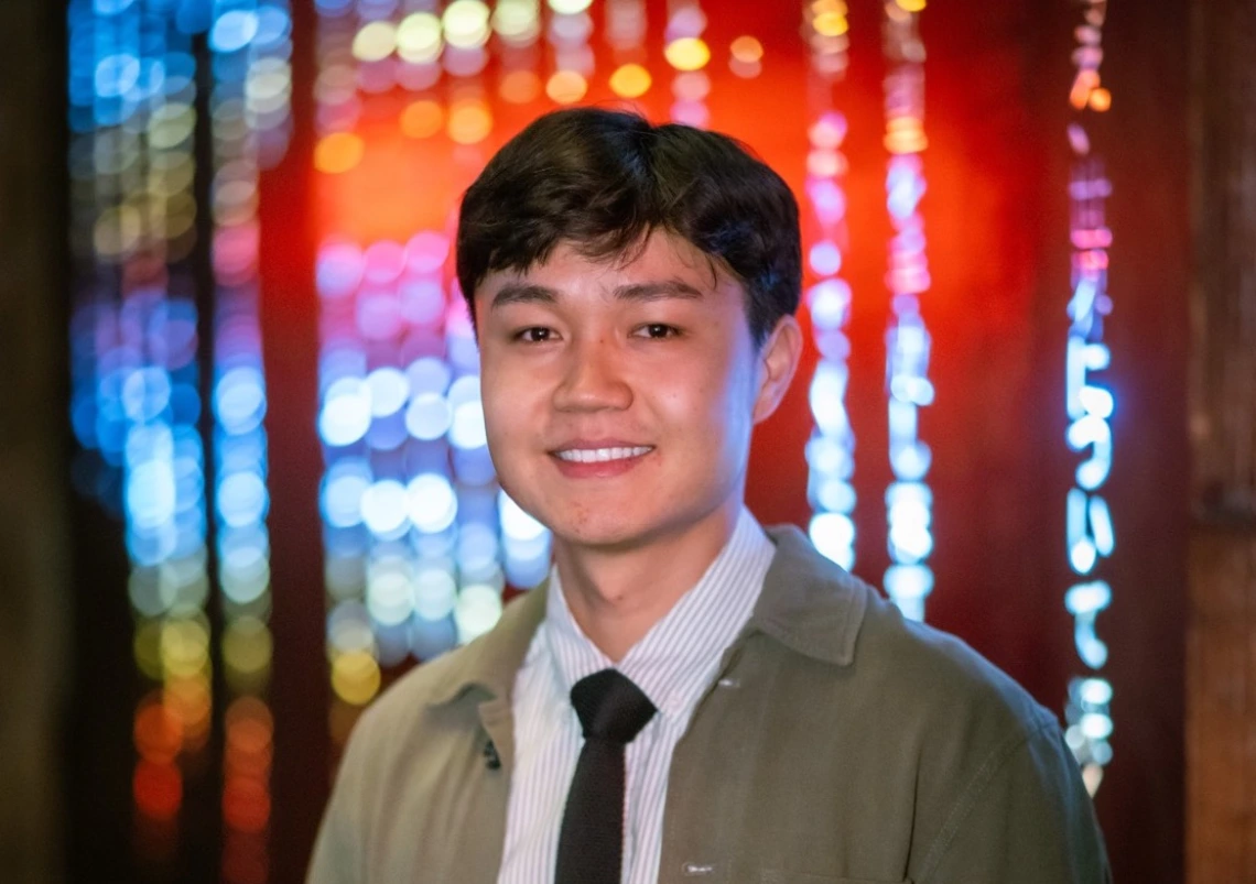 student headshot with neon red and blue background