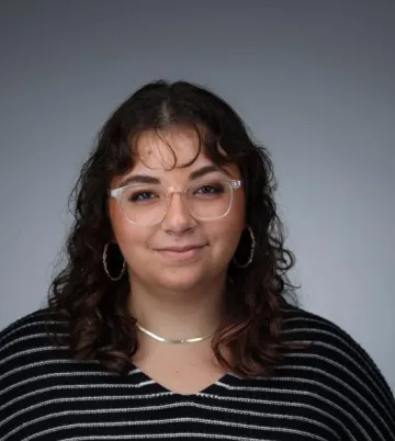 headshot of woman with grey background